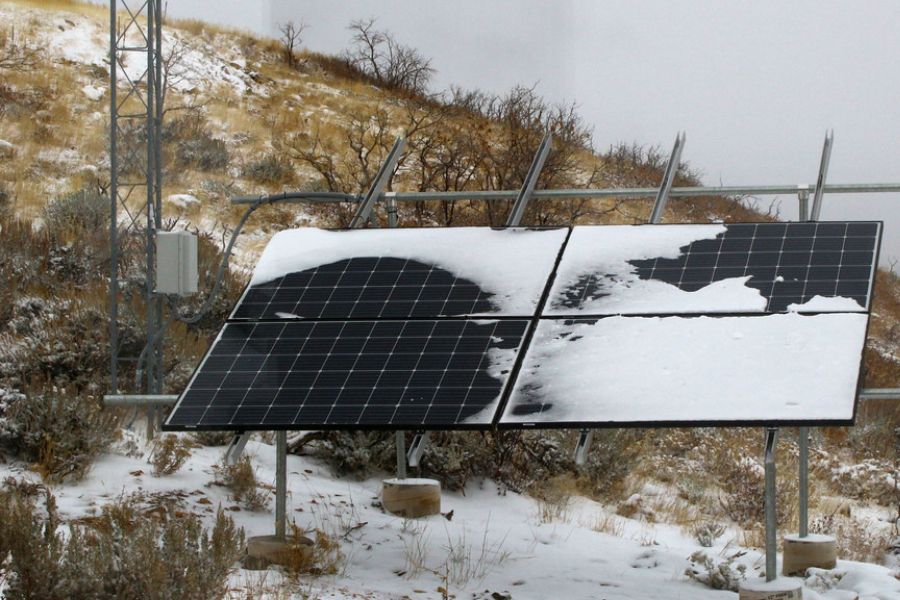Solar panels partly covered with snow in winter