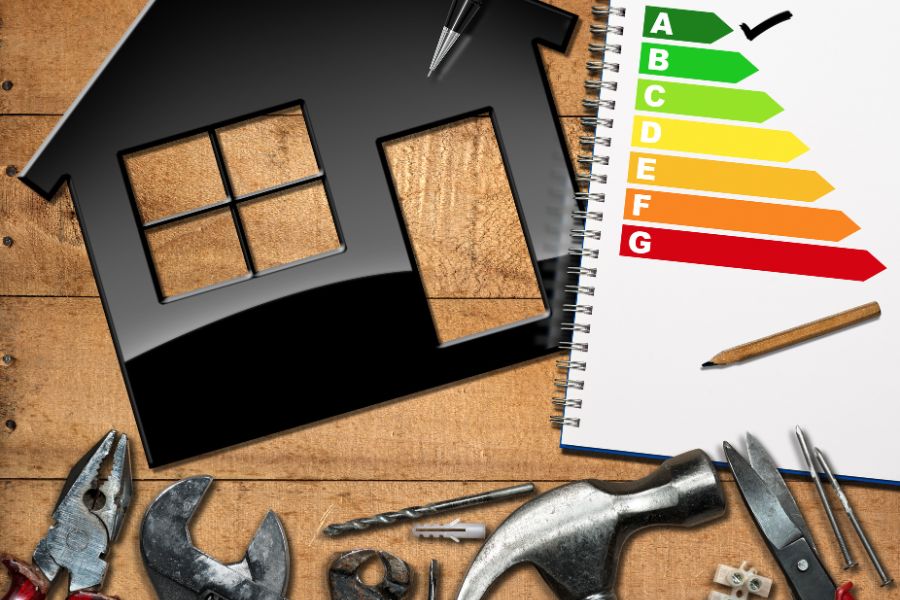 Home Improvement concept with house model and energy rating and tools