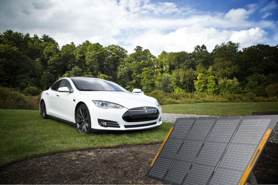 Tesla car and portable solar panels outdoors
