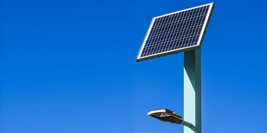solar powered street light with solar panels on top and blue sky background